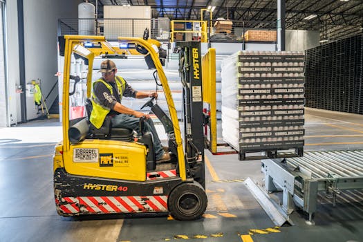pexels-photo-1267338-1267338-2 A warehouse worker maneuvers a forklift to transport crates for brewing company storage.
